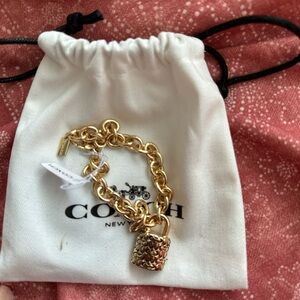 Chunky gold Coach bracelet with lock
